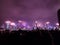 diverse people enjoying an impressive display of fireworks in Hong Kong during countdown of New Year