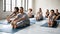 Diverse people practicing yoga with instructor, Seated forward bend exercise