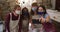 Diverse potters wearing face masks and aprons taking a selfie using smartphone at pottery studio