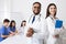 Diverse Professional Doctors In White Coats Posing To Camera At