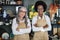 Diverse saleswomen smiling and standing with arms crossed at decor store