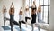 Diverse sporty young people practicing yoga, doing Vrksasana exercise