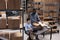 Diverse storehouse workers putting client order in carton box wrapped package in bubble wrap