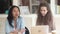 Diverse students girls talking sitting at desk in classroom