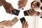 Diverse team employees using phones together bottom view