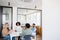 A diverse team of professionals gathers around a table for a collaborative session