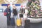 Diverse tourists with Christmas tree at airport terminal