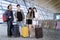 Diverse tourists standing with suitcases at the airport