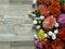 Diverse vibrant colours chrysanthemum bunch on bleached oak wood background.White, yellow, orange, pink, purple chrysanthemum.