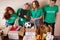 Diverse volunteers packing, collecting humanitarian aid in donation box