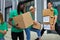 Diverse volunteers packing, collecting humanitarian aid in donation box