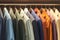 Diverse wardrobe Hanging colorful mens suits in a closet