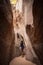 Diverse woman rock climbing in a beautiful slot canyon near Zion National Park