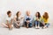 Diverse Women Sitting On Floor Talking And Smiling Indoor