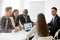 Diverse work team listening to female leader explaining strategy