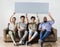 Diverse workers sitting on couch holding empty banner