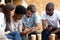 Diverse young people busy using smartphones together