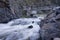 Diversion dam on a mountain river flowing in deep,