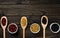 Diversity of beans inside wooden spoons. Black wood background