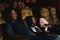 Diversity children and people, american black, caucasian and asian, having fun watching movie in cinema theater