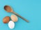 A diversity of eggs. Three chicken, hens eggs on turquoise kitchen board. Different colors: brown white and speckled.