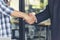 Diversity two business partners shaking hands together with business contract mergers and acquisitions. Close up honest hands