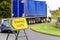 Diverted traffic sign on UK motorway junction with lorry truck in background in England