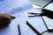 Divider, pencil, pen, ruler, glasses and smartphone and blueprint on table top.Table top view of Engineers table at office