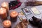 Divination cards alignment with black Buddha statue, money banknotes and candles. Mystery, astrology, fortune telling, belief