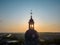 Divine Dawn: Church Dome Silhouetted Against the Sunrise