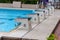 Diving block stands with numbers in outdoor swimming pool on rainy day