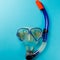 Diving equipment. Snorkeling mask and tube on blue background. Colorful background