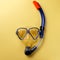 Diving equipment. Snorkeling mask and tube on yellow background. Colorful background