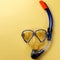 Diving equipment. Snorkeling mask and tube on yellow background. Colorful background. Top view. Copy space