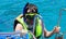 A diving man climbs aboard the boat after swimming