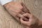 Divorce, separation: man removing wedding or engagement ring, top view