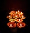 Diwali, Deepavali Hindu festival of lights. Diya lamp lit on black, close up