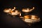 Diwali diyas or clay lamps on black background