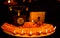 Diwali glowing Diya , flowers, Sweets and Gifts arranged in circular shape forming a design with copy space, selective focus ,