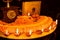 Diwali glowing Diya , flowers, Sweets and Gifts arranged in circular shape forming a design with copy space, selective focus ,