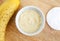 Diy banana mask face cream in the small white bowl, make-up brush, cotton pads and banana. Natural homemade hair treatment