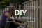 DIY concept with a woman building a garden fence