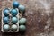 DIY dyed various shades of blue Easter eggs on retro rusty metal background. Happy Easter.