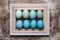 DIY dyed various shades of blue Easter eggs and vintage wooden picture frame mock up.