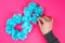 Diy eight made cardboard decorated artificial flower made blue tissue paper napkin pink background