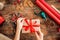 DIY Gift Wrapping. Woman wrapping beautiful red christmas gifts on rustic wooden table. Overhead point of view.