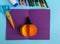 Diy Halloween card with pumpkin on purple background.Gift idea, decor Halloween.Instruction.Step by step.Top view. Children