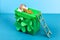 DIY leprechaun trap with gold coins, rainbow and green ladder St Patricks Day background