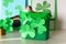 DIY leprechaun trap with gold coins, rainbow and green ladder St Patricks Day background