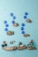 Diy painted stone fish on blue background and sea decoration. Creative DIY idea, surreal imagination kids world. Kid handmade,